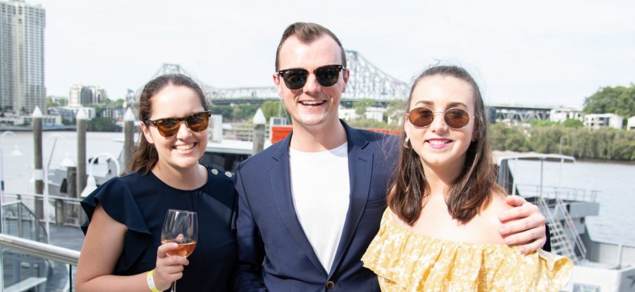 Three people smiling at event