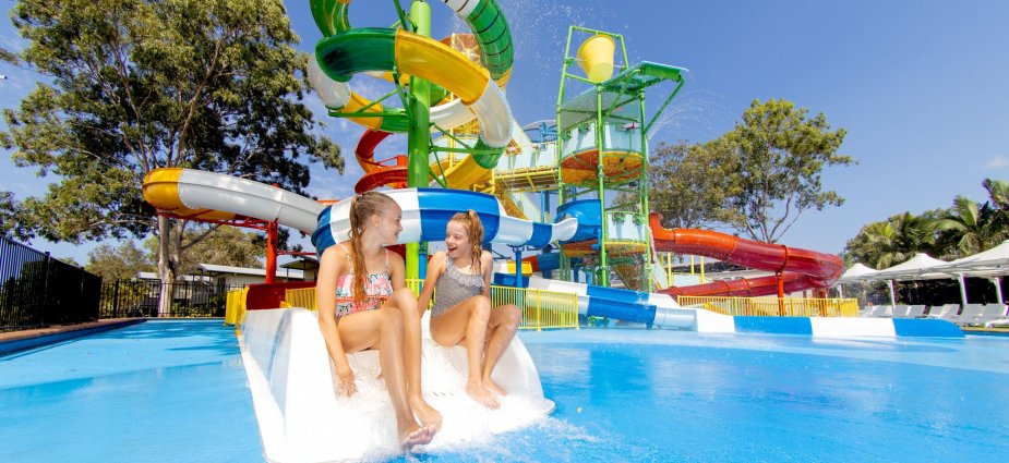 Two children sit at water park
