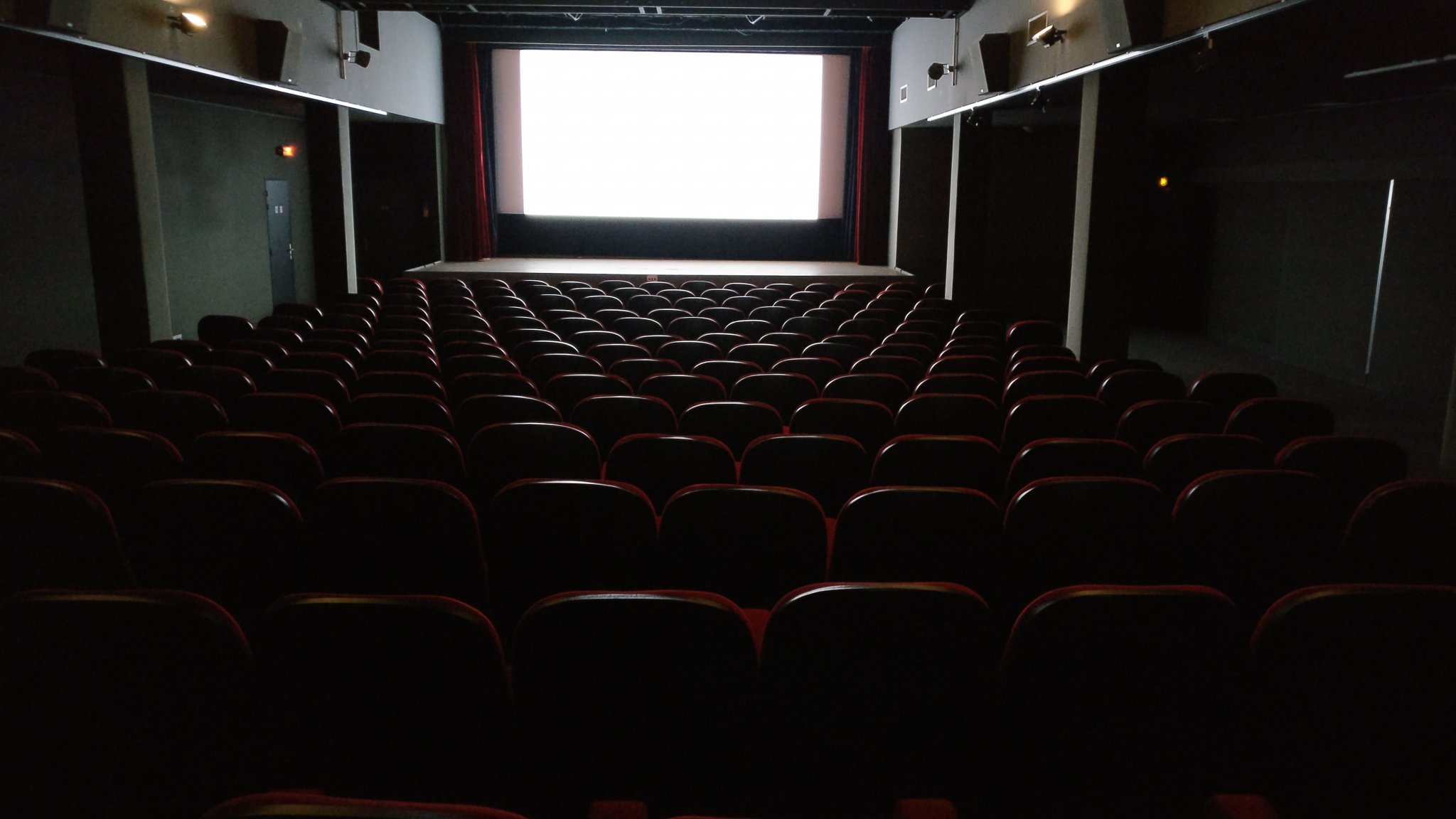 Cinema seats showing white screen
