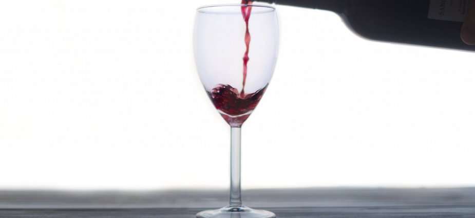 Wine bottle pouring into glass